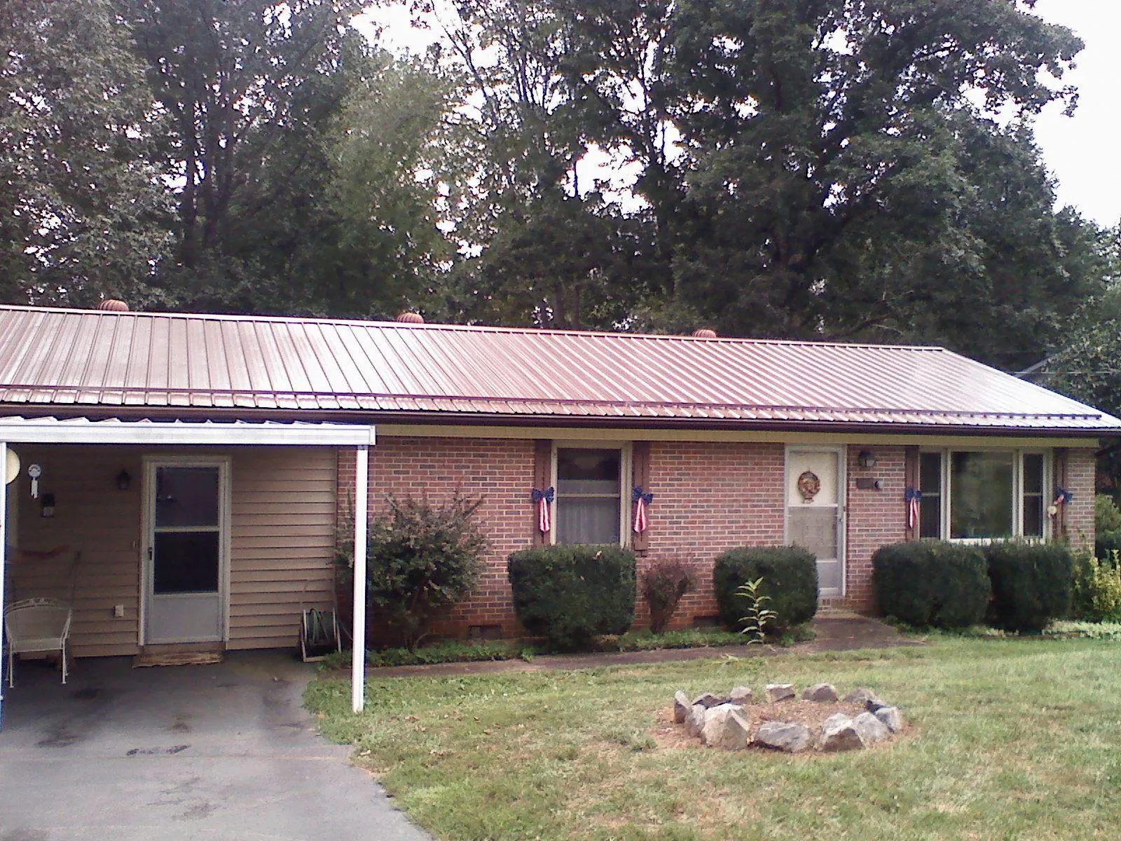 Bronze metal roof and carport on a brick ranch home — Roof Repair work by our crew in Annandale On Hudson